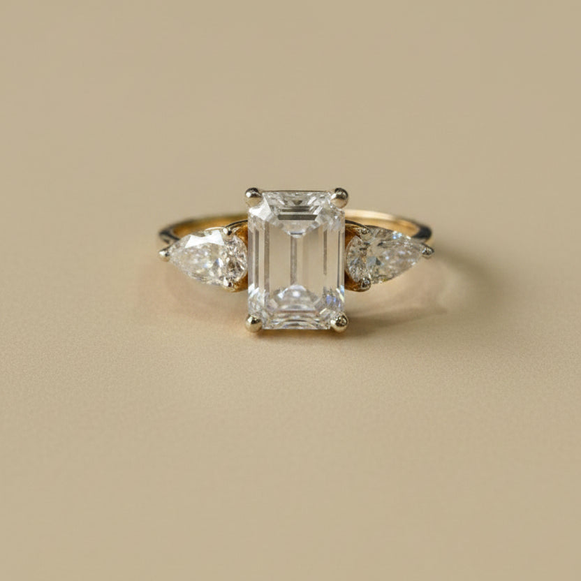 Emerald & pear cut three stone ring